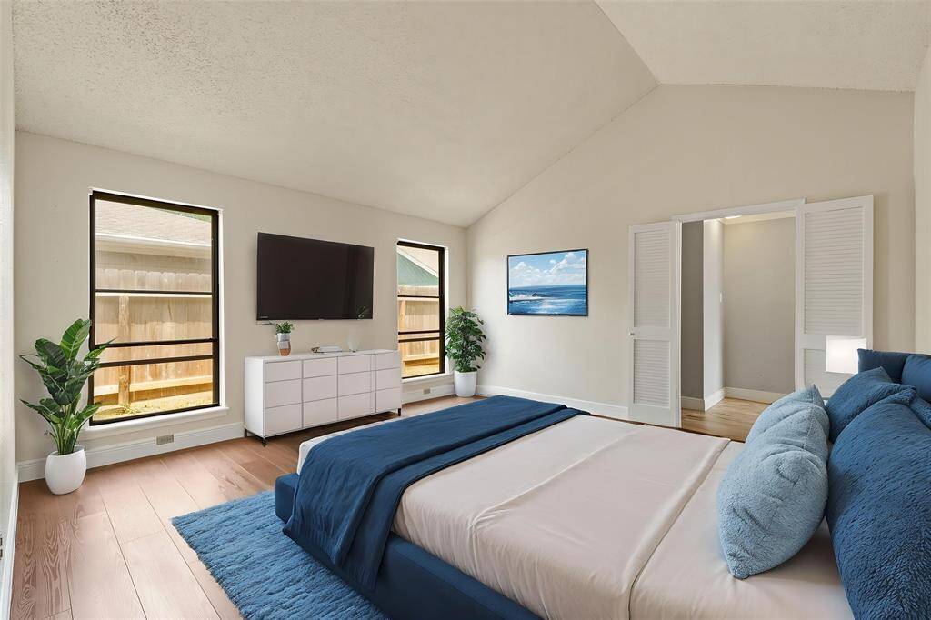 Virtually Staged: Unwind after a long day in this incredible primary bedroom! Featuring lots of natural light, hardwood floors, and a high vaulted ceiling.