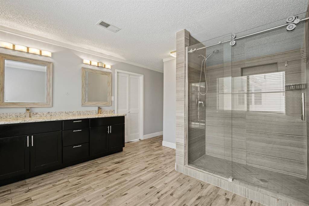 What an amazing Primary Bathroom! This incredible space features a stunning glass enclosed shower.