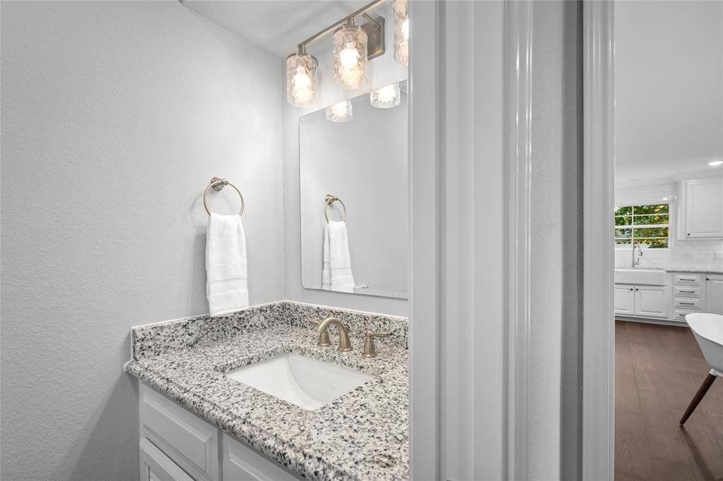 POWDER BATH - Sleek hardware and beautiful countertops. Powder bath is tucked off the mudroom.