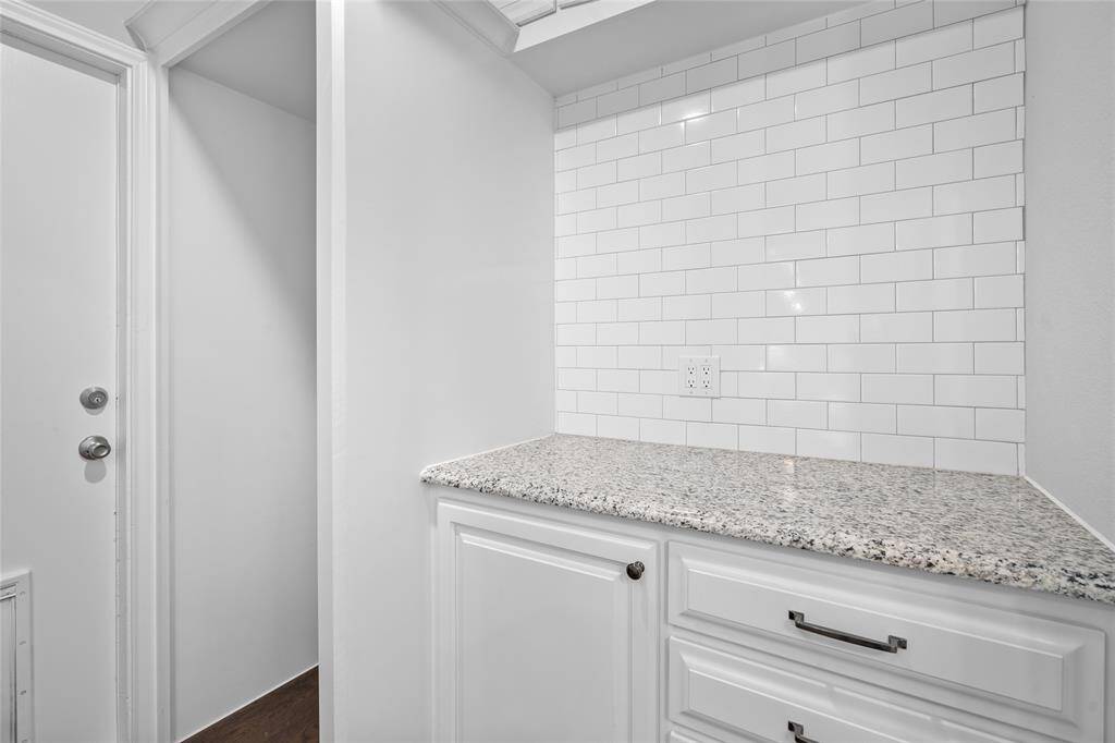 UTILITY ROOM - Plenty of storage/drop space for shoes and backpacks. Set up for a stackable washer/dryer to maximize additional storage space.