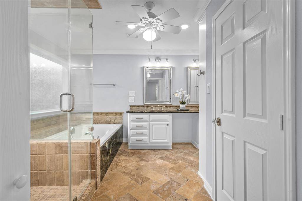 PRIMARY BATHROOM - A separate glass walled shower and soaking tub!