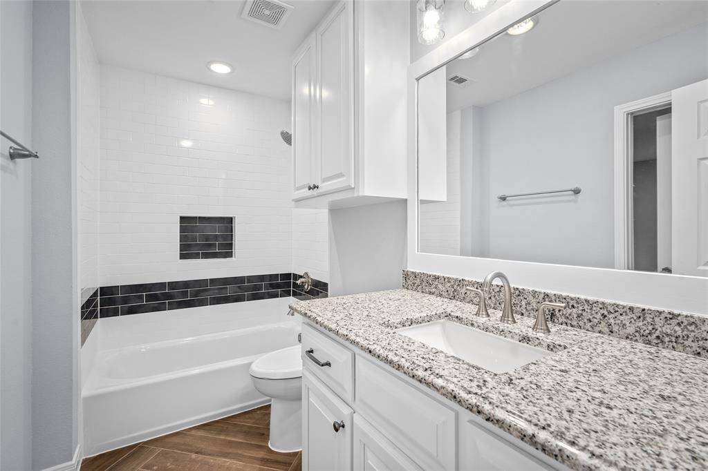 SECONDARY BATHROOM- This en suite bathroom has a shower/tub combo and is also open to the hallway for easy access.