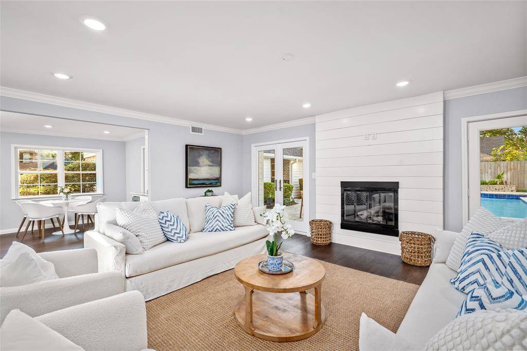 LIVING ROOM - Anchored by a beautiful fireplace and views of the fabulous backyard and pool! Gas log fireplace with shiplap detailing.
