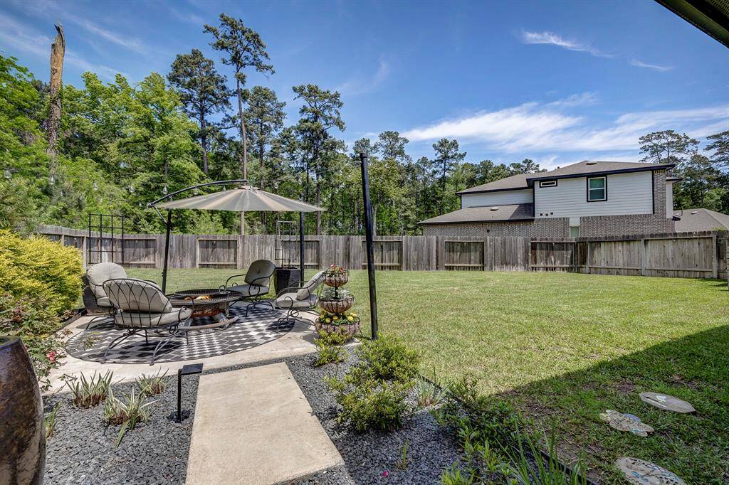 Ceiling fans, extended back patio leading to additional seating area to host outdoors