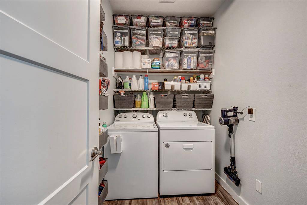 Laundry/Utility Room: highlights spacious shelving, tall ceilings and room to house cleaning appliances.