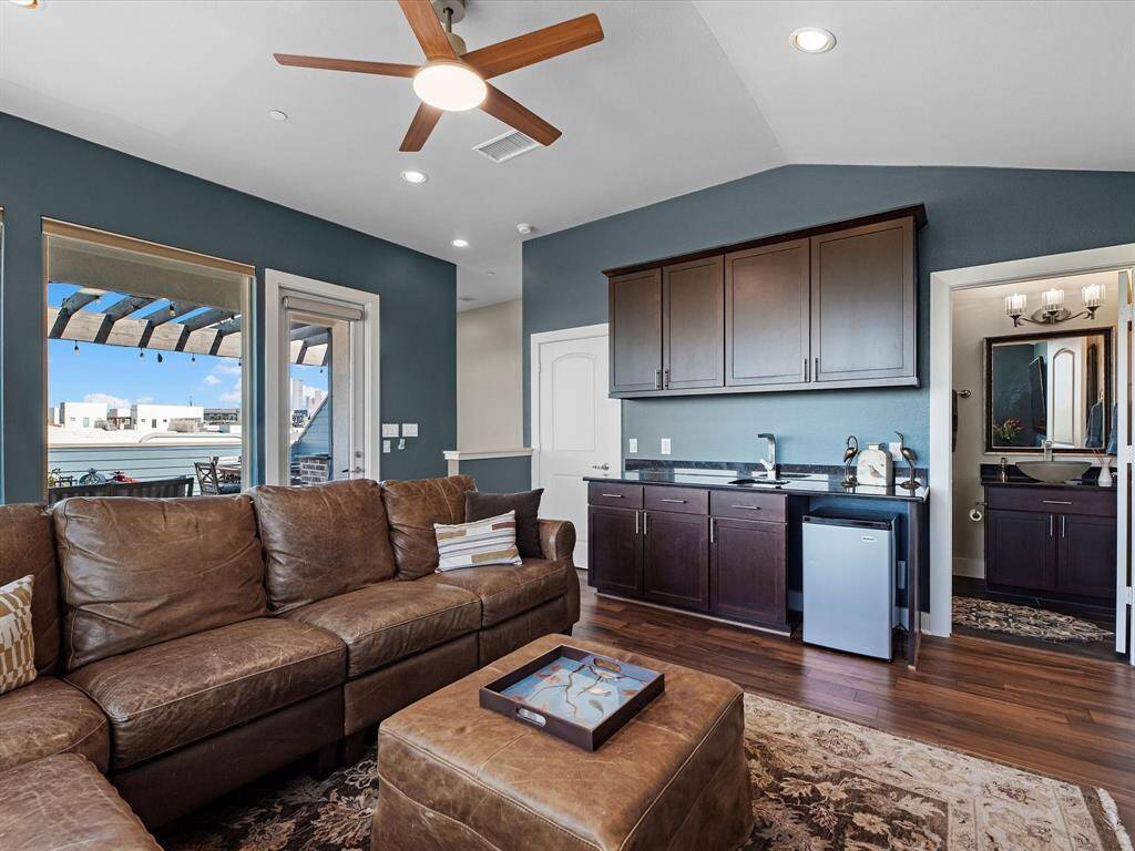 This versatile space features warm wood flooring, with its own private full bathroom and closet, it can easily function as a fourth bedroom, guest suite, or second living area—perfect for flexible living needs.