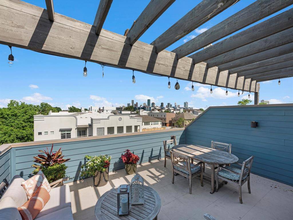 Expansive rooftop terrace with a pergola, offering stunning city skyline views—perfect for relaxing or entertaining under the stars.