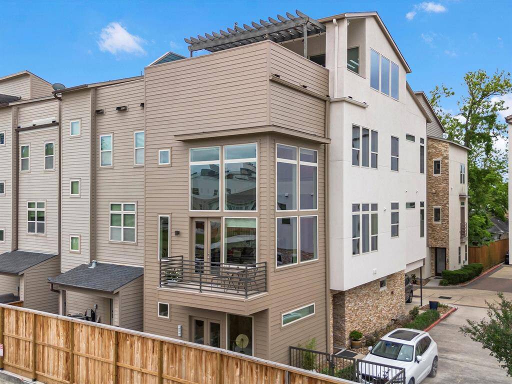 Aerial view from White Oak Bayou showcasing the home’s proximity to the hike and bike trail, surrounding greenery, and peaceful residential setting—offering a unique perspective of the property’s location and lifestyle.