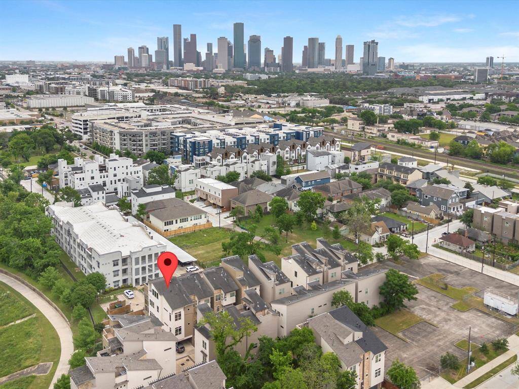Nestled in a vibrant neighborhood with lush greenery and a park nearby. The location offers a clear view of the city skyline, combining urban convenience with suburban tranquility.