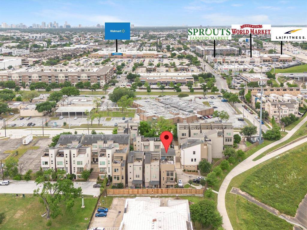 Aerial view of community located near key amenities. Nearby, there's a Walmart, Sprouts Farmers Market, World Market, and LA Fitness, offering convenient shopping and fitness options. The area is residential with easy access to major retailers and services.