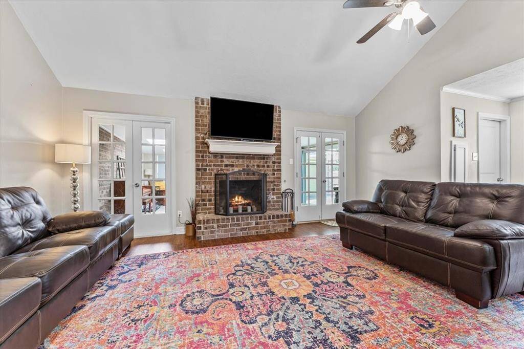 This home offers a large living room and a brick fireplace.