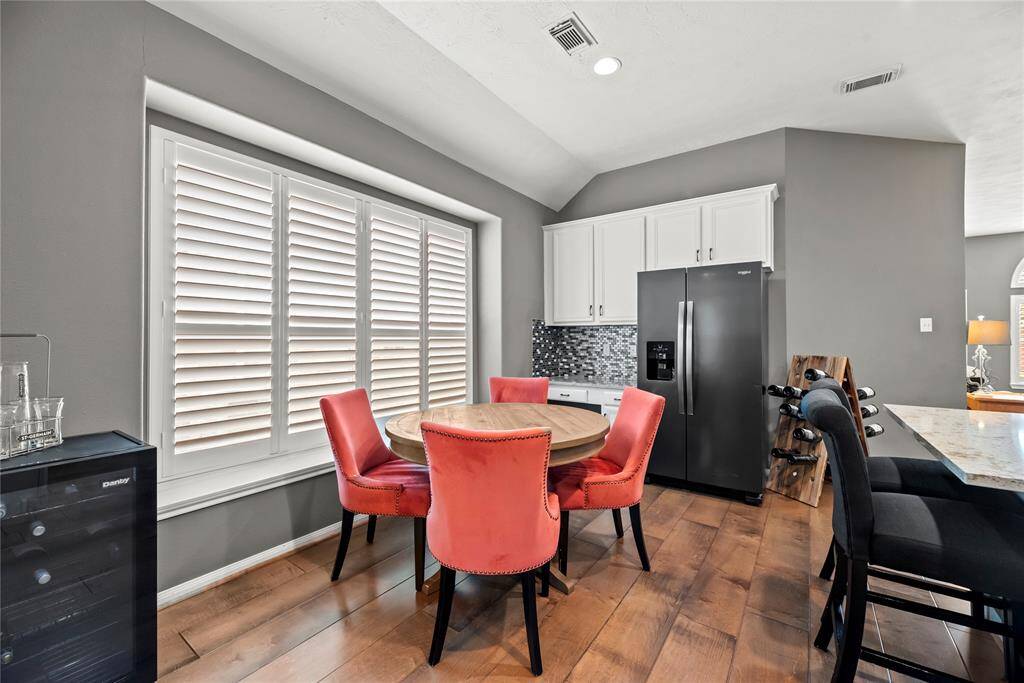Breakfast area with a corner desk for homework and bills, extra window seating and plantation shutters for that dose of morning sunshine.
