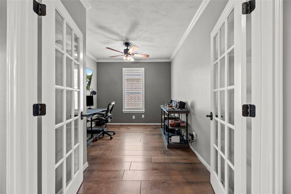 Elegant French doors lead to a spacious home office or bonus room, perfect for working from home or pursuing hobbies.