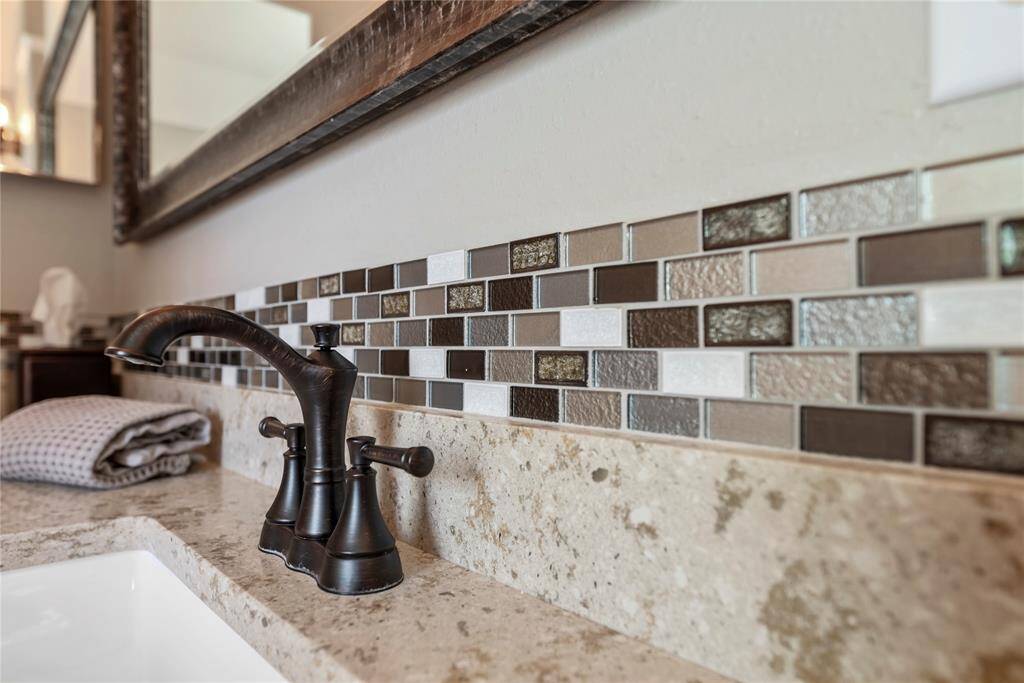 Bronze faucets? Check! Sleek backsplash? Check! Quartz countertops?Check! We've got all the essentials covered in this bathroom ,folks!