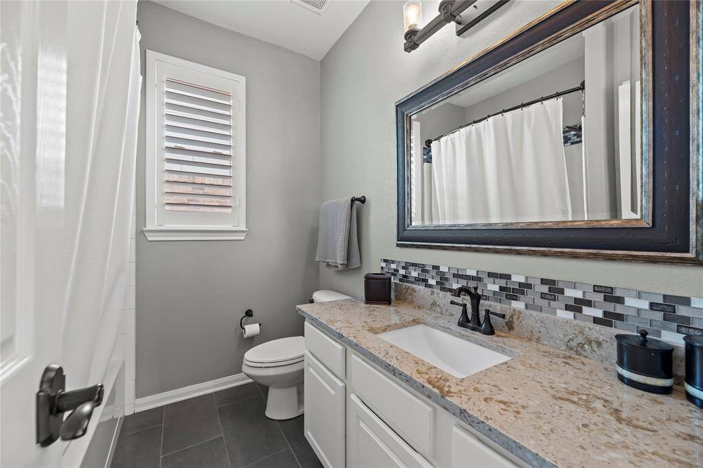A conveniently located guest bathroom serves as a shared facility for the two secondary bedrooms.