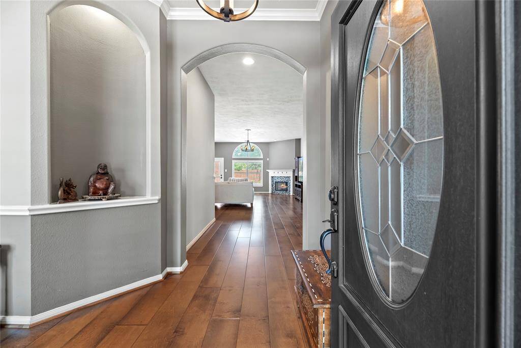 Step into this immaculate home and be greeted by striking engineered hardwood floors and tasteful architectural archways.