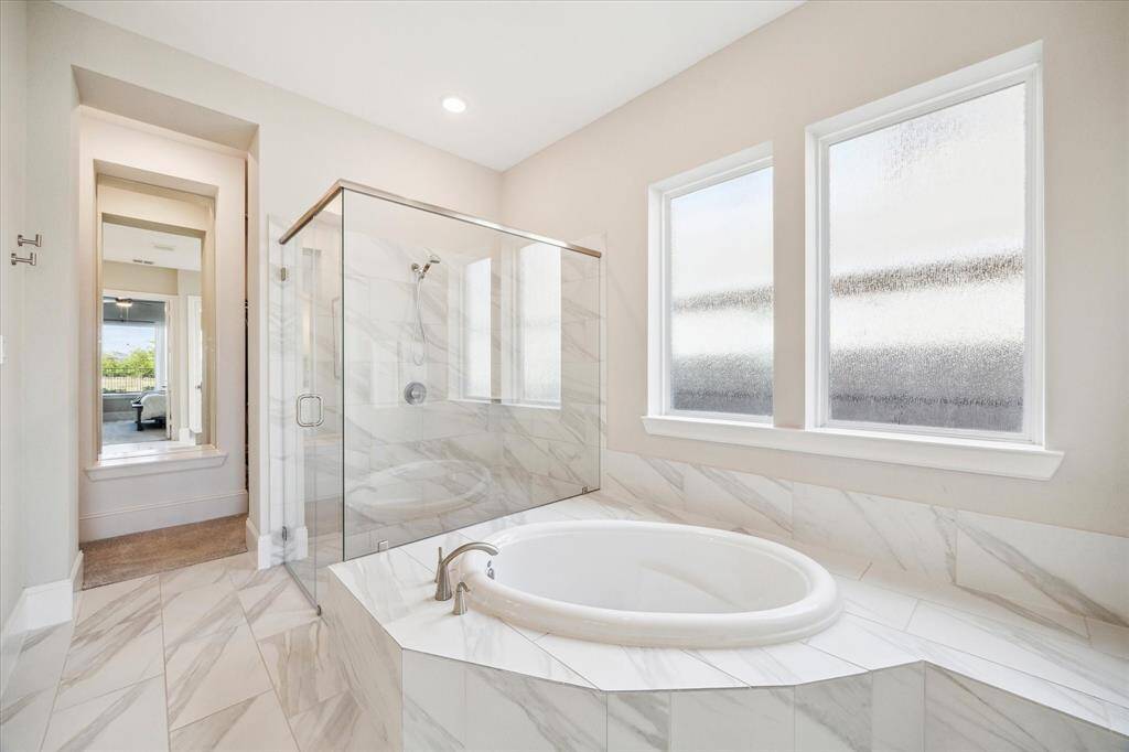 Primary bathroom has large soaking tub and separate shower.