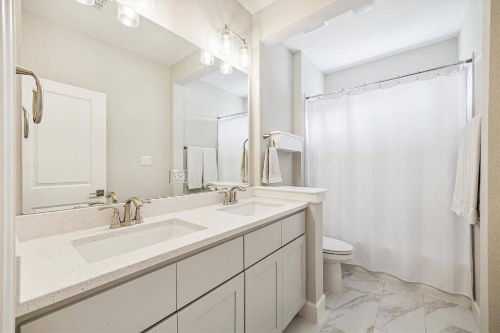 Dual sinks and bathroom on the second floor.