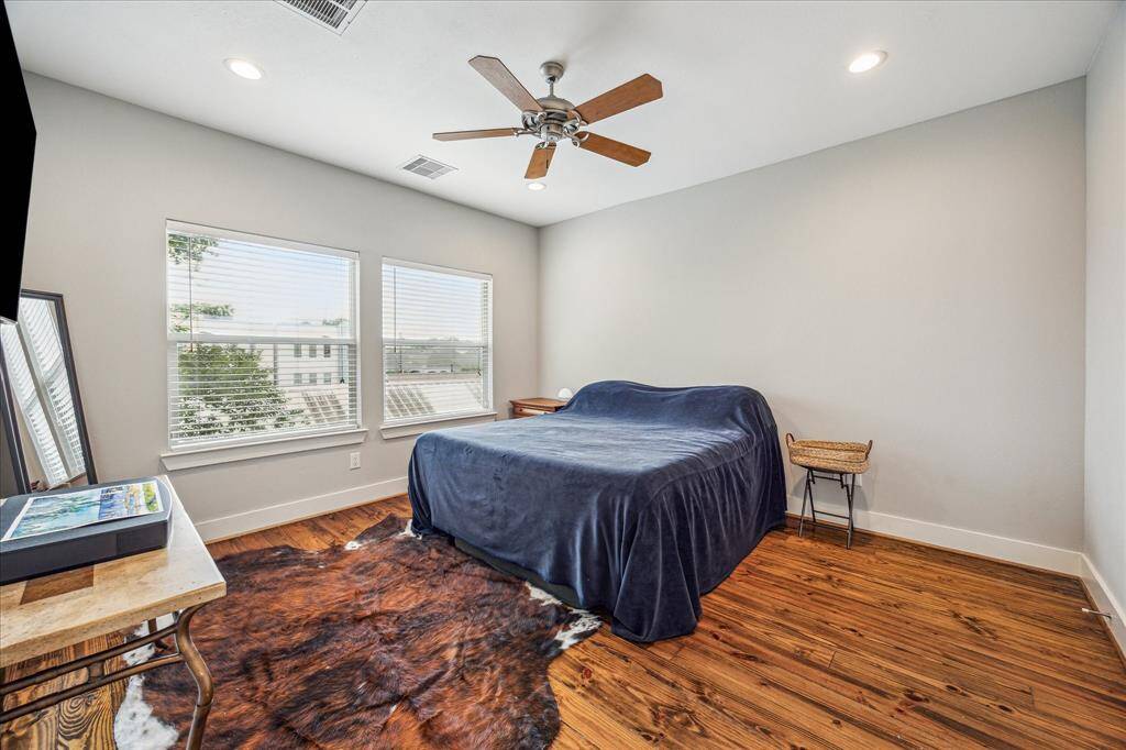 Primary bedroom with hardwoods