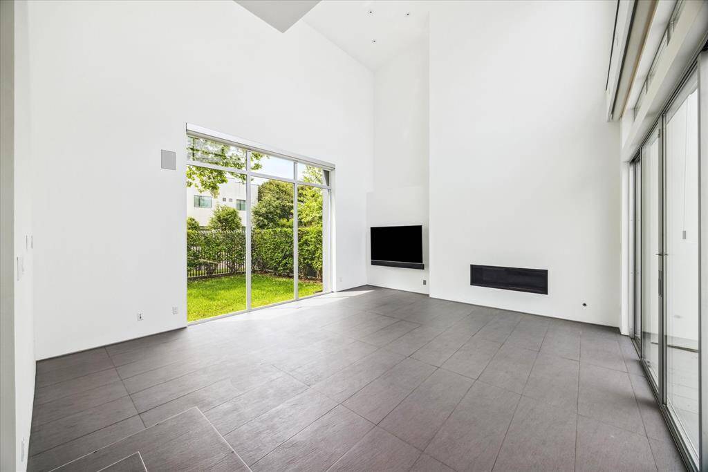 Large living area that overlooks front yard and pool