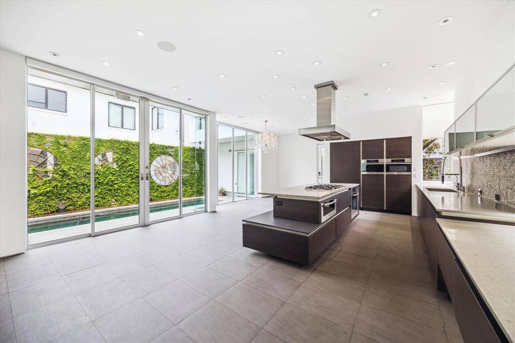 Large kitchen with breakfast and dining space that overlooks the sparking pool