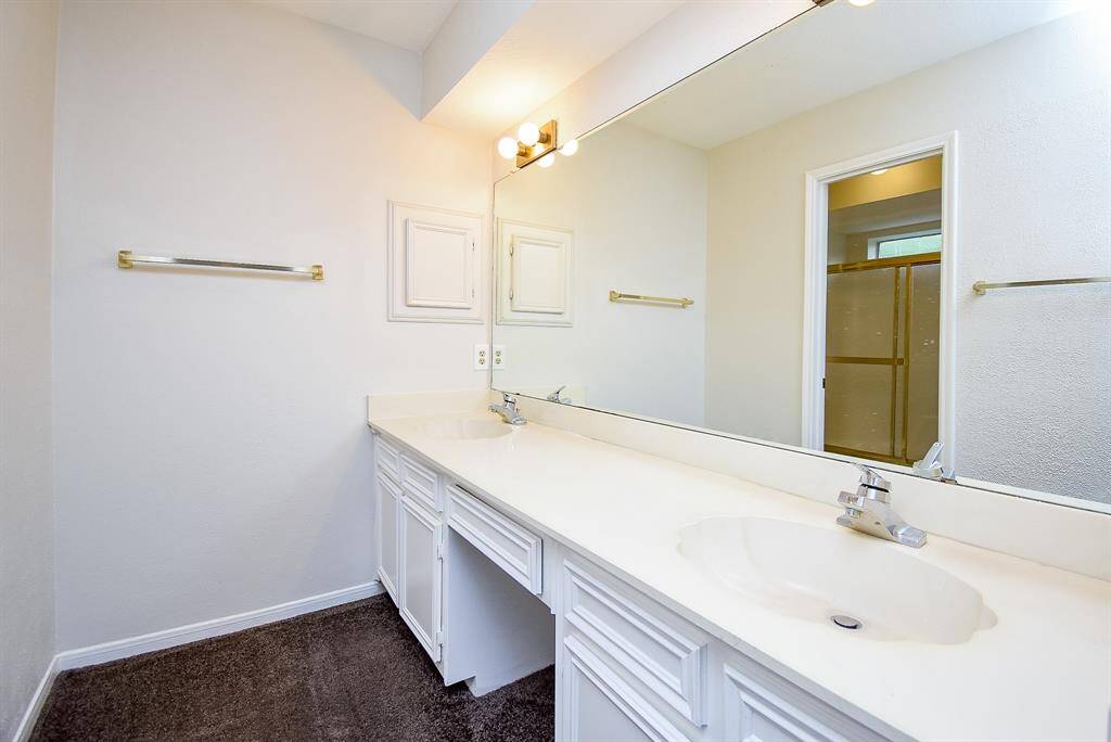Primary bathroom with dual sinks and ample vanity space.