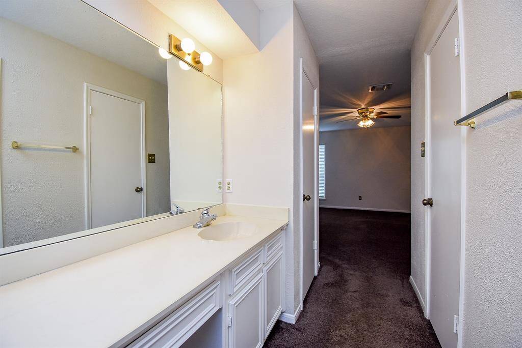 Bathroom leads into the comfortable, carpeted bedroom.