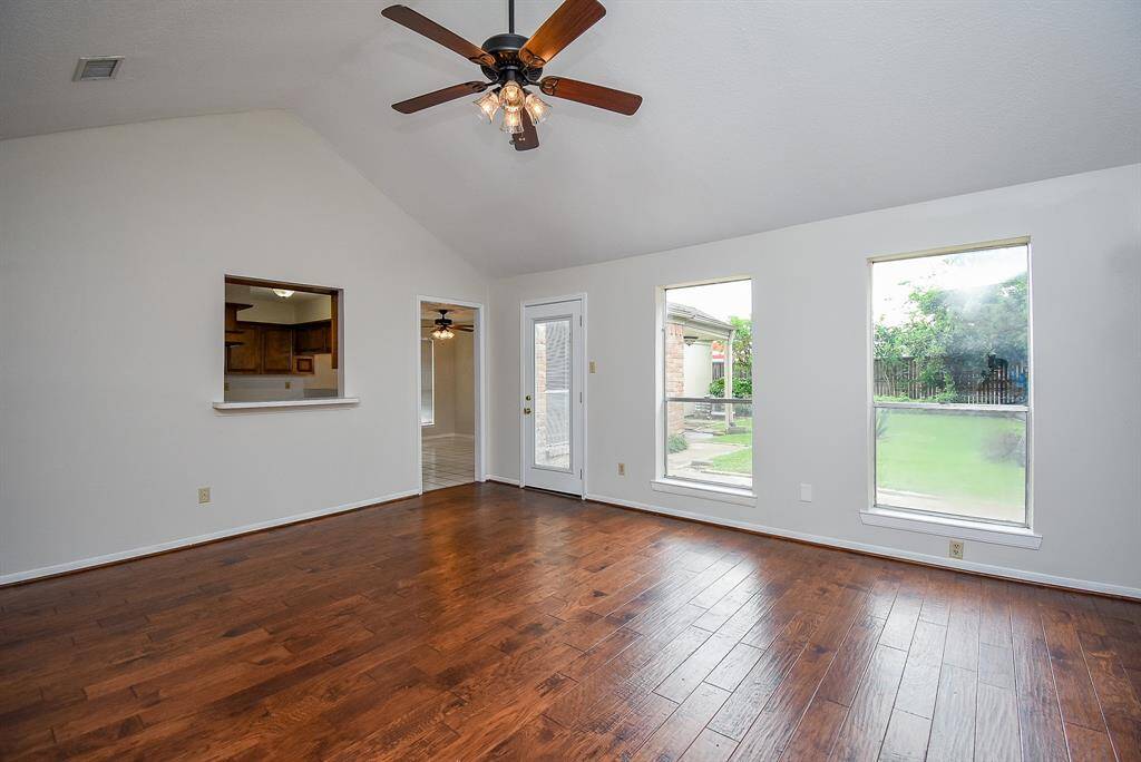 Vaulted ceilings & large windows flood the living room with light.