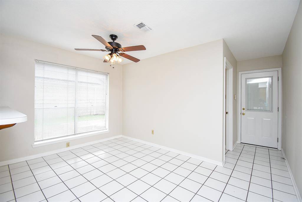 Breakfast nook with door leading to outdoor areas and garage walkway.