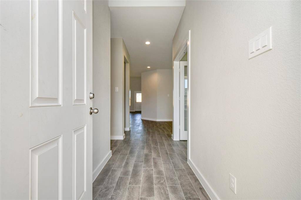 As you step into the threshold of this luxurious home, you'll soon be welcomed by anelegant glass door (to be installed). Inside, soaring ceilings amplify the spaciousness,while the refined wood-look tile flooring and oversized baseboards exudesophistication and charm. Sample photo of completed home with similar floor plan. Actual colors and selections may vary.