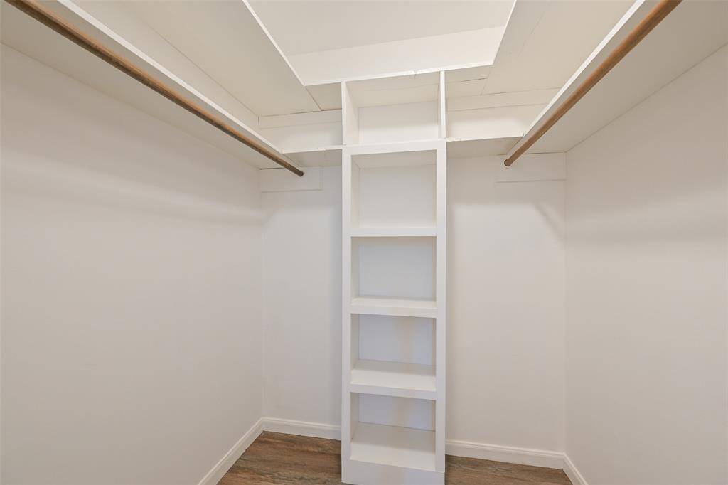 WALK-IN CLOSET OFFERS SHELVES FOR EASY ORGANIZING AND PLENTY OF SPACE.