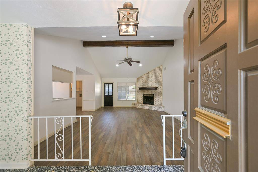 THE ENTRANCE HALL OPENS UP TO THE FAMILY ROOM WITH VINYL PLANK FLOORING.