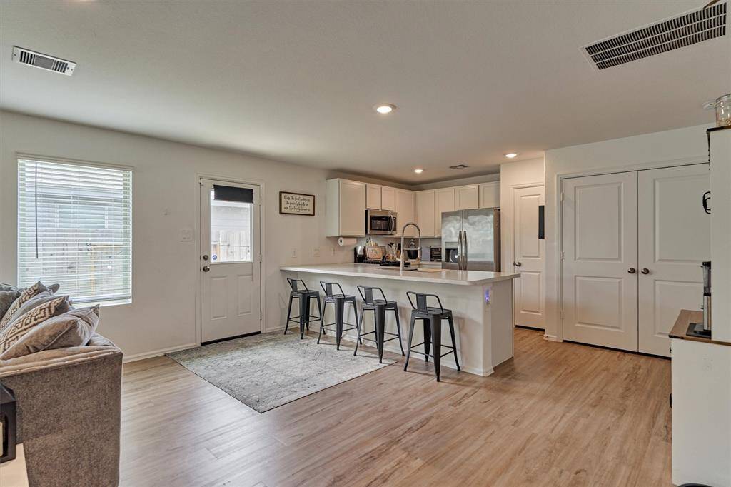 Breakfast bar for additional setting and plenty of room for a kitchen table.