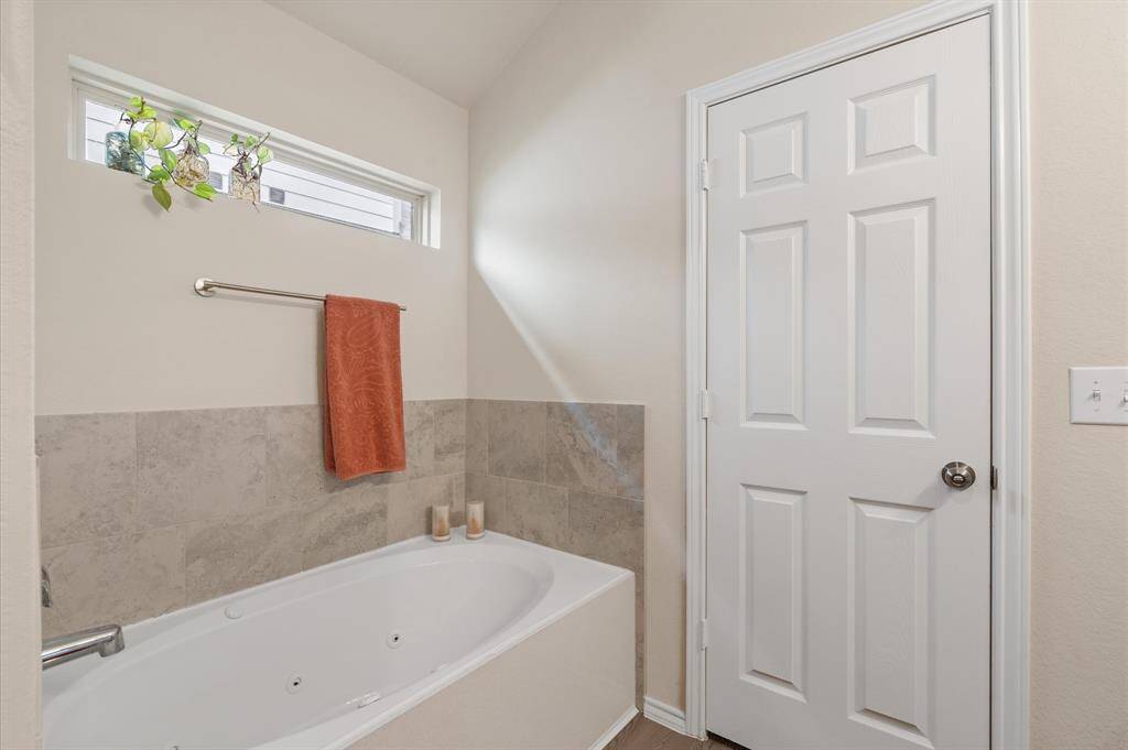 Primary bathroom has separate tub.