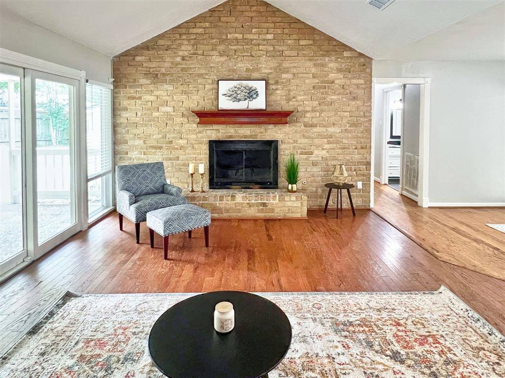Living room with vaulted ceiling and gas fire place as a focal point in the room