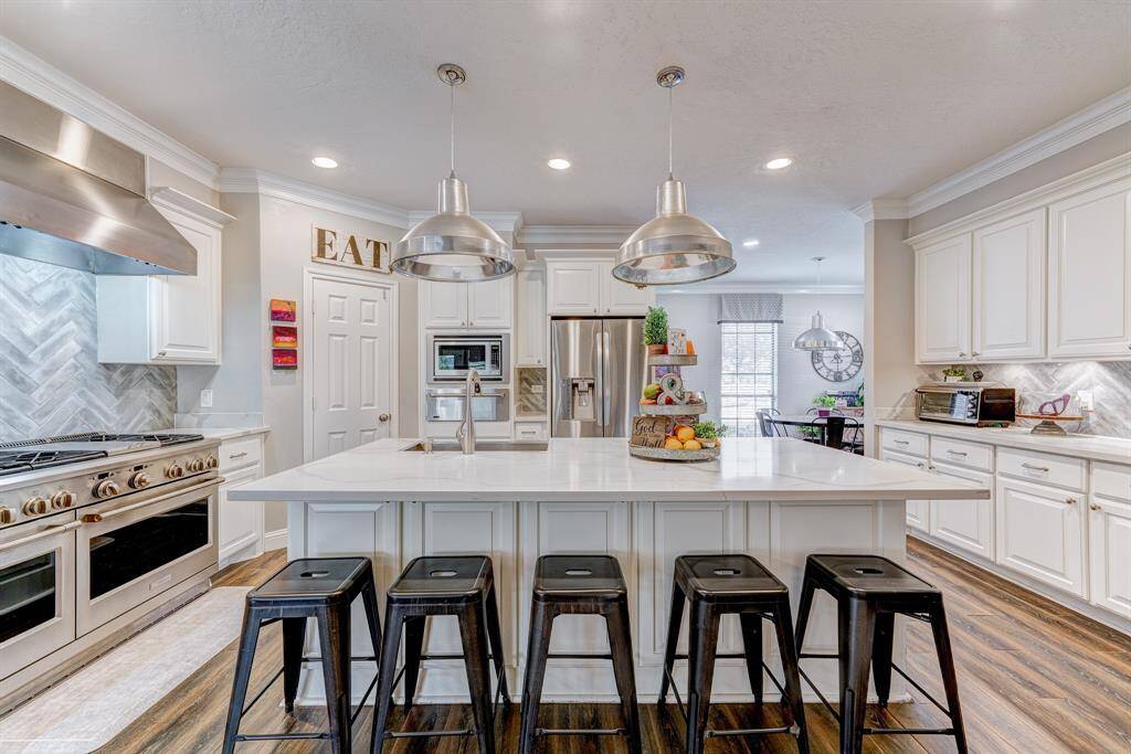 Large island with sink and plenty of space for stools and gatherings.