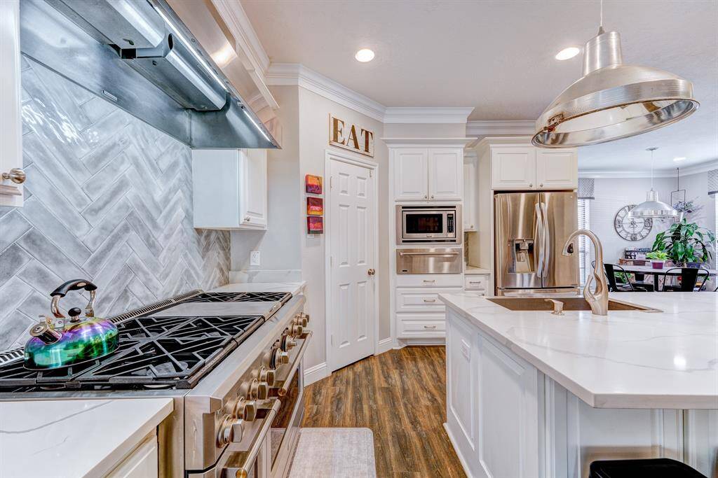 Top of the line range with a griddle and two ovens and 6 burners.