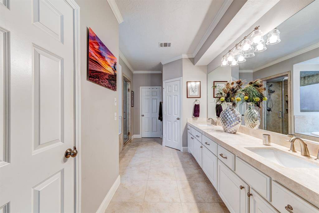 Primary bathroom has double sinks and separate shower and soaking tub.