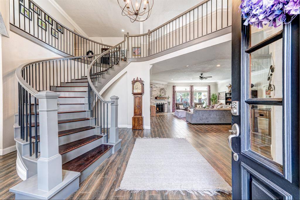 Sweeping staircase with open foyer.