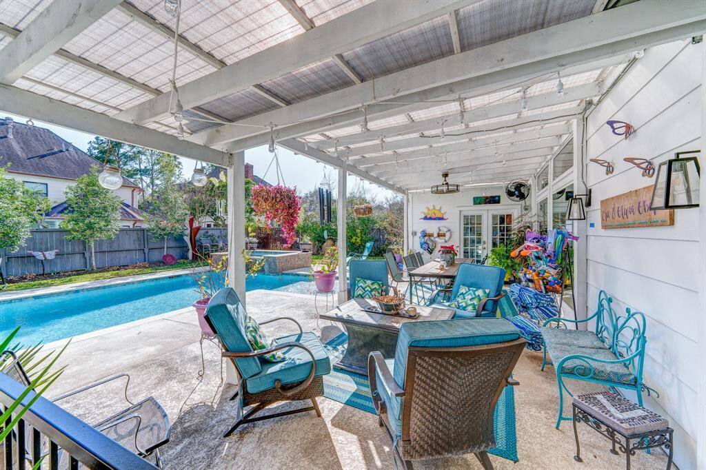 Large covered porch with removable metal fence.