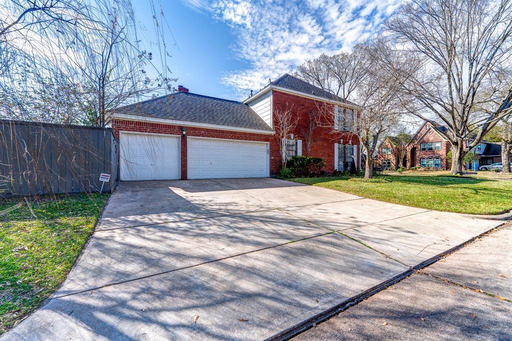 Three car garage is accessed from Bayou River.