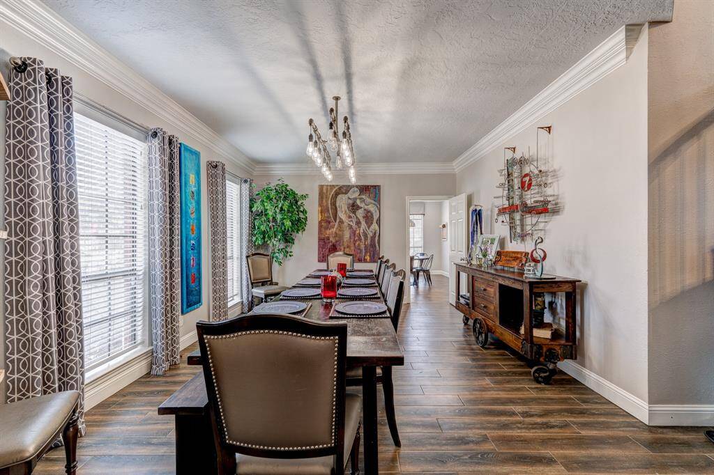 To the left of the entry is a large dining room and custom chandelier.