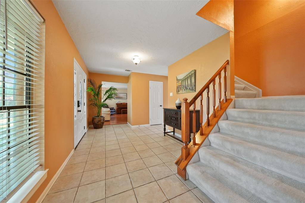 Inviting foyer leading seamlessly into a spacious formal living room.