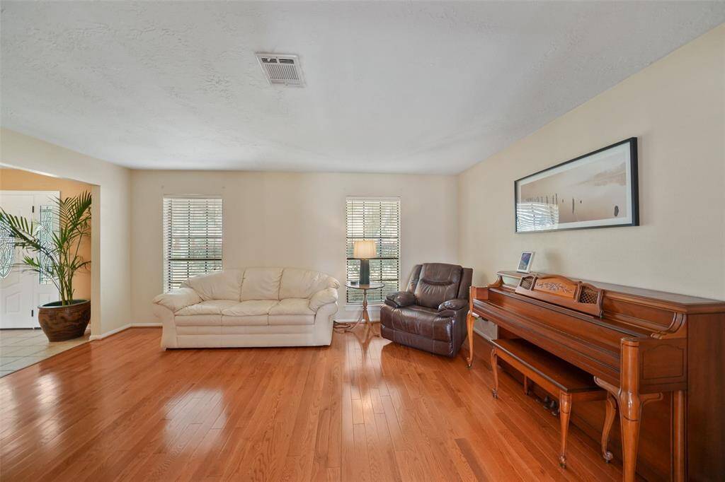 Bright formal living room with elegant wood floors.