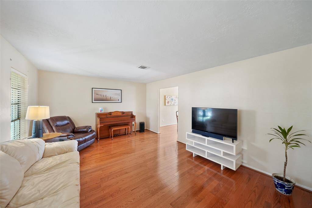 Spacious formal living room with seamless entry to the elegant dining area.