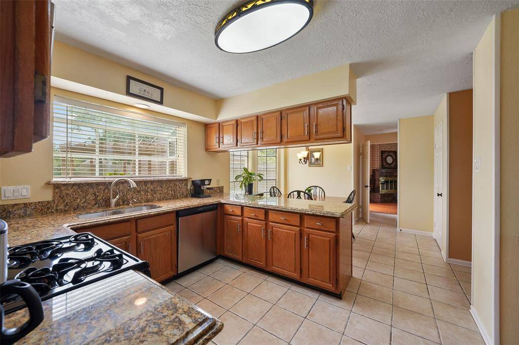 Discover the inviting kitchen and breakfast area, featuring ample natural light and elegant cabinetry.