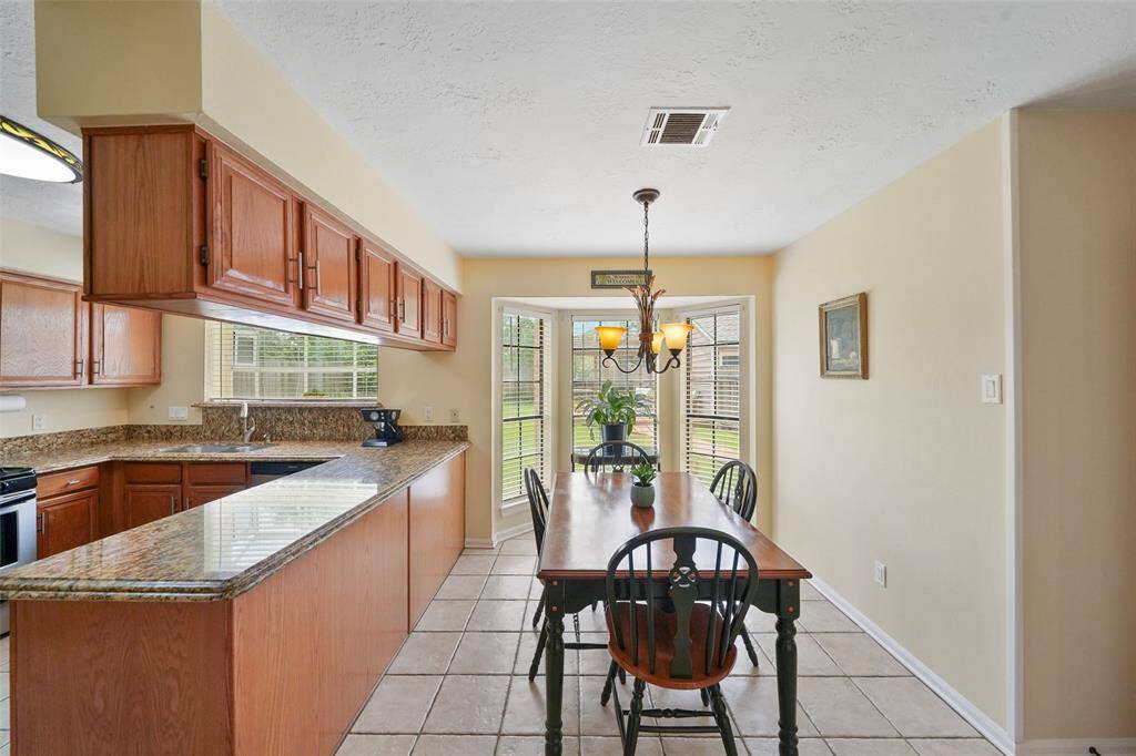 Cozy breakfast nook with abundant natural light and charming backyard views.