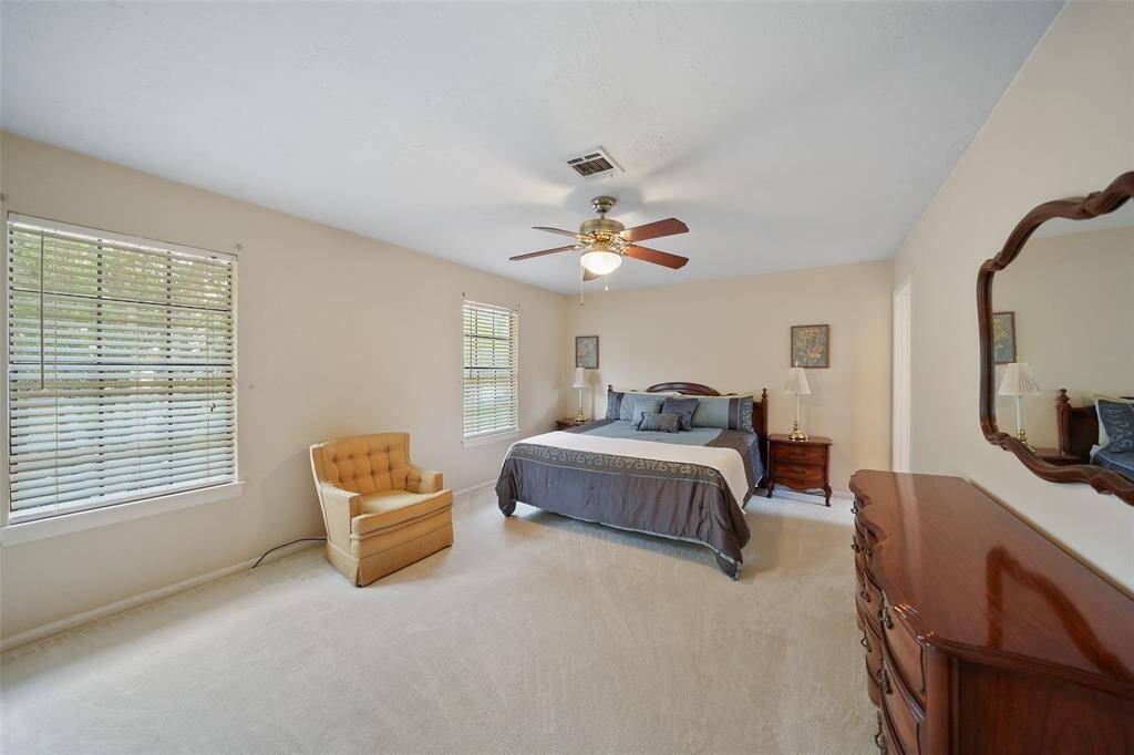 Spacious primary bedroom with abundant natural light and elegant design.