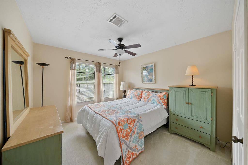 Cozy and bright secondary bedroom with ample natural light and stylish decor.