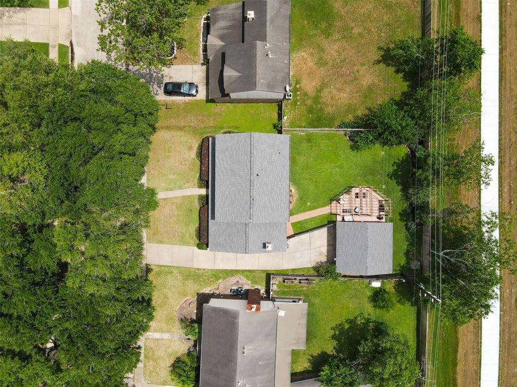 Discover the charm of 15935 Pinyon Creek Dr from above, showcasing its spacious layout, lush greenery, and inviting outdoor space.